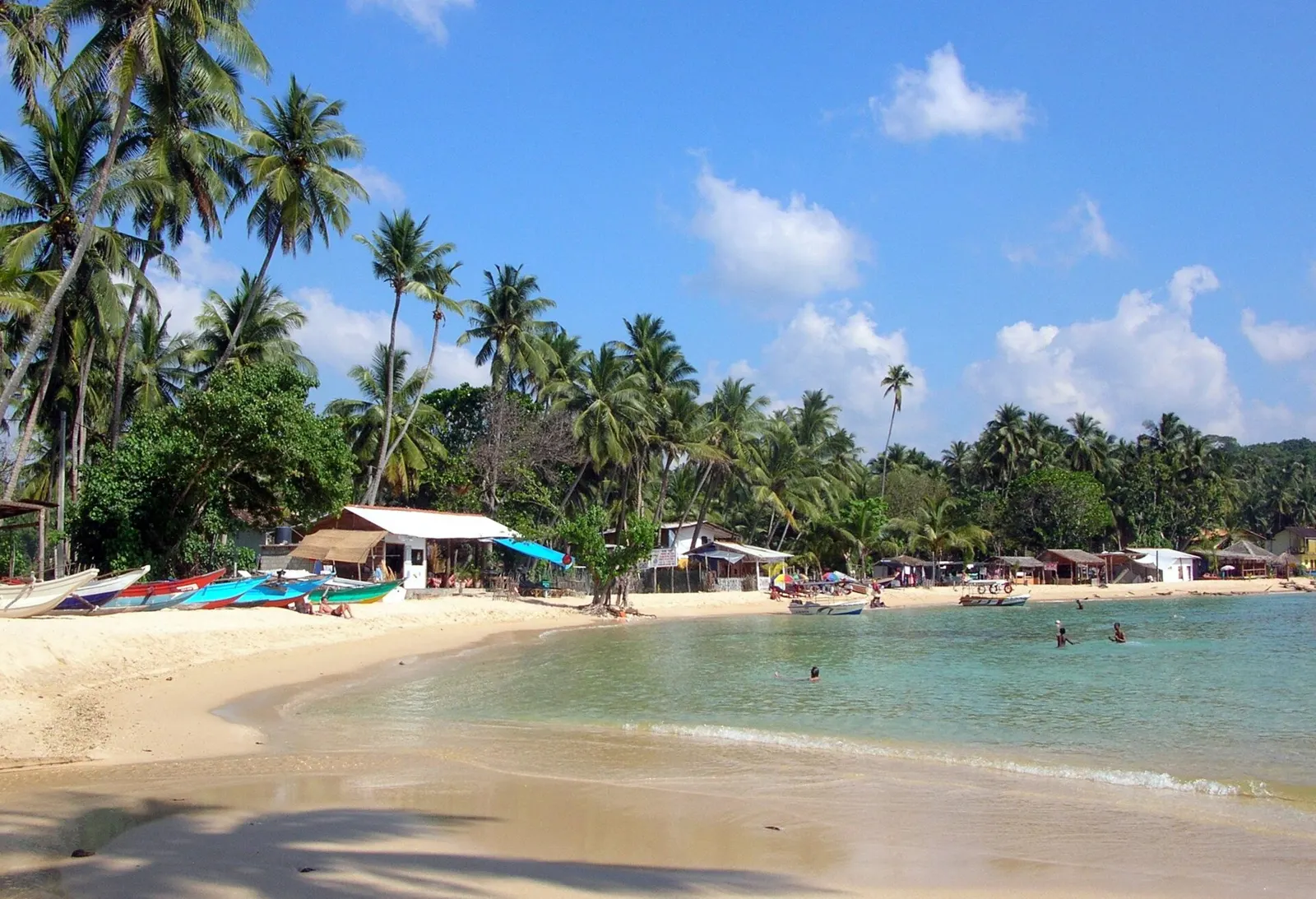 Curved sandy bay and calm turquoise waters at Unawatuna beach